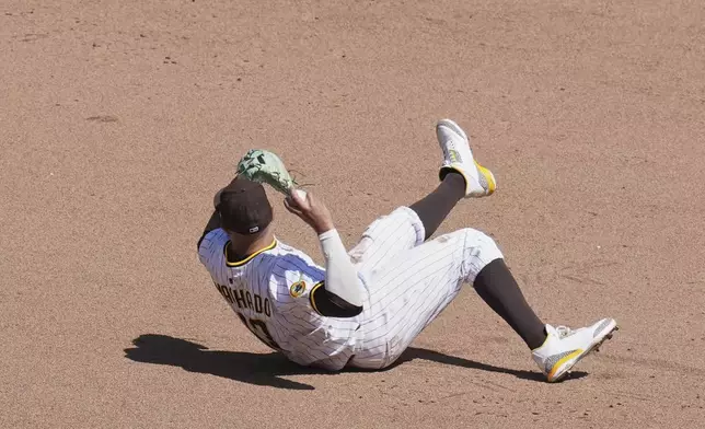 San Diego Padres third baseman Manny Machado throws to second from the dirt for the out on San Francisco Giants' Mike Yastrzemski on a force out by Willy Adames during the sixth inning of a baseball game Wednesday, April 30, 2025, in San Diego. (AP Photo/Gregory Bull)
