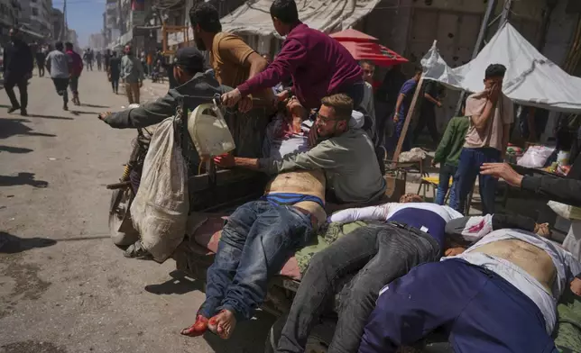 Bodies of some of the victims of an Israeli army strike on a restaurant, which killed at least 29 people, are transported from the scene to a hospital in Gaza City, Wednesday, May 7, 2025.(AP Photo/Jehad Alshrafi)
