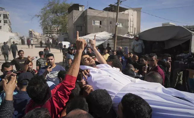 The body of man who was killed along with at least 28 others in an Israeli army strike on a restaurant, is carried for burial at Shifa hospital in Gaza City, Wednesday, May 7, 2025. (AP Photo/Jehad Alshrafi)