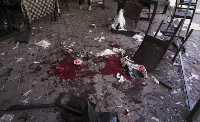 Blood is splattered across the floor following an Israeli army strike on a restaurant that killed at least 29 people in Gaza City, Wednesday, May 7, 2025.
