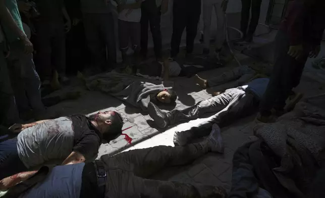 Bodies of some of the victims of an Israeli army strike on a restaurant, which killed at least 29 people, lie on the floor after the were taken from the scene to the Shifa hospital in Gaza City, Wednesday, May 7, 2025.(AP Photo/Jehad Alshrafi)
