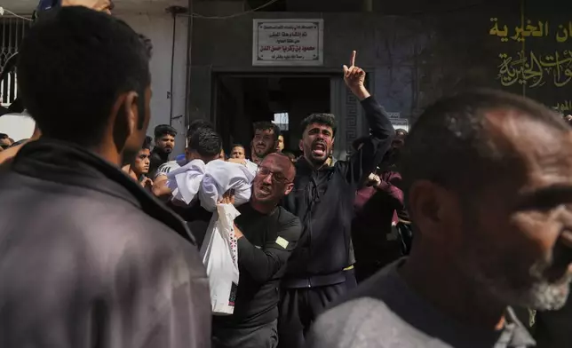 Bodies of some of the victims of an Israeli army strike on a restaurant, which killed at least 29 people, are carried at the Shifa hospital in Gaza City, Wednesday, May 7, 2025.(AP Photo/Jehad Alshrafi)