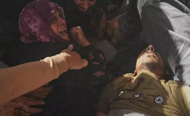 A woman reacts over the bodies of some of the victims of an Israeli army strike on a restaurant, which killed at least 29 people, as they are carried from the scene to a hospital in Gaza City, Wednesday, May 7, 2025.(AP Photo/Jehad Alshrafi)