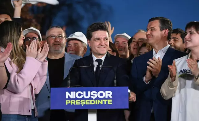 Presidential candidate Nicusor Dan smiles after polls closed for the first round of the country's presidential election redo in Bucharest, Romania, Sunday, May 4, 2025. (AP Photo/Eduard Vinatoru)