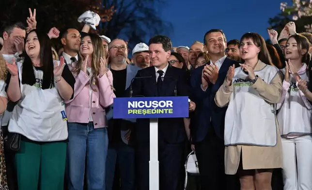 Presidential candidate Nicusor Dan smiles after polls closed for the first round of the country's presidential election redo in Bucharest, Romania, Sunday, May 4, 2025. (AP Photo/Eduard Vinatoru)
