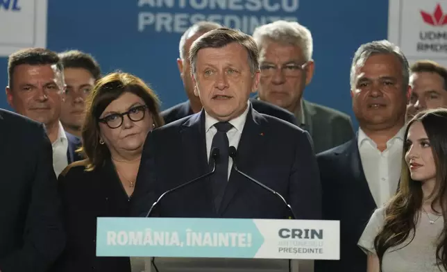 Presidential candidate Crin Antonescu, centre, attends a meeting with supporters after polls closed for the first round of the country's presidential election redo in Bucharest, Romania, Sunday, May 4, 2025. (AP Photo/Vadim Ghirda)