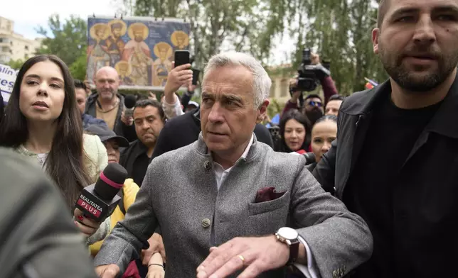 Calin Georgescu, the winner of the first round of last year's annulled election, arrives at a prosecutor's office in Bucharest, Romania, Tuesday, May 27, 2025. (AP Photo/Vadim Ghirda)