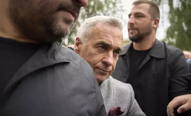 Calin Georgescu, the winner of the first round of last year's annulled election, arrives at a prosecutor's office in Bucharest, Romania, Tuesday, May 27, 2025. (AP Photo/Vadim Ghirda)