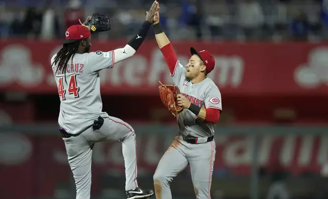 Cincinnati Reds' Elly De La Cruz (44) and TJ Friedl, celebrate after their baseball game against the Kansas City Royals, Tuesday, May 27, 2025, in Kansas City, Mo. (AP Photo/Charlie Riedel)