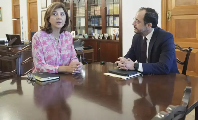 U.N. chief's personal envoy for Cyprus, Maria Angela Holguin Cuellar, left, talks with Cyprus' President Nikos Christodoulides during their meeting at the Presidential Palace in the divided capital Nicosia, Cyprus, on Saturday, May 24, 2025. (AP Photo/Petros Karadjias)