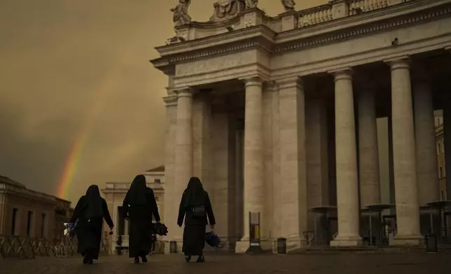 FILE - Nuns walk along St. Peter's Square during the fourth day of mourning for late Pope Francis at the Vatican, Tuesday, April 29, 2025. (AP Photo/Francisco Seco, File)