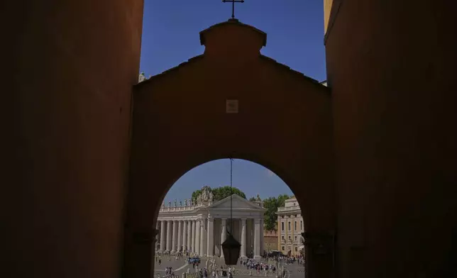 FILE - The faithful and tourists walk along St Peter's square on the sixth day of mourning for late Pope Francis at the Vatican on Thursday, May 1, 2025. (AP Photo/Francisco Seco, File)