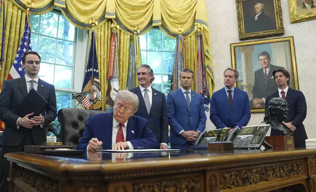 President Donald Trump signs an executive order regarding reinvigorating the nuclear industrial base, in the Oval Office of the White House, Friday, May 23, 2025, in Washington. (AP Photo/Evan Vucci)