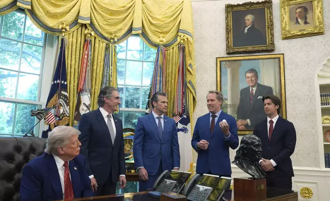 President Donald Trump, Interior Secretary Doug Burgum, Defense Secretary Pete Hegseth and Scott Nolan, CEO of General Matter, right, listen as Jacob DeWitte, CEO of Oklo Inc., speaks before Trump signed executive orders regarding nuclear energy in the Oval Office of the White House, Friday, May 23, 2025, in Washington. (AP Photo/Evan Vucci)