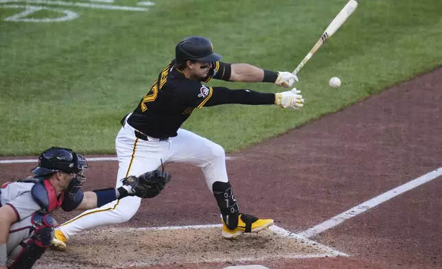 Pittsburgh Pirates' Matt Gorski singles off Atlanta Braves pitcher Daysbel Hernández, driving in a run, during the eighth inning of a baseball game in Pittsburgh, Saturday, May 10, 2025. (AP Photo/Gene J. Puskar)