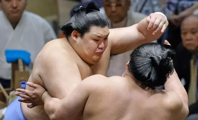 Onosato, left, wrestles with Wakamotoharu in a sumo wrestling tournament at Ryogoku Kokugikan arena in Tokyo, Sunday, May 11, 2025. (Taichi Nagahisa/Kyodo News via AP)