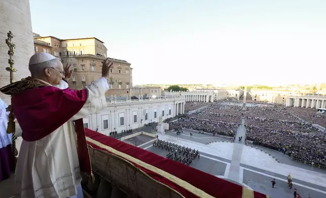 Newly elected Pope Leo XIV waves to faithful and pilgrims gathered in St. Peter's Square shortly after his election, Thursday, May 8, 2025. (Vatican Media via AP)