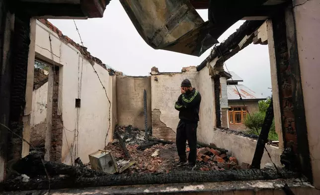 Mohammad Sahil reacts as he stands inside his house damaged by Pakistani artillery shelling, at Salamabad village in Uri, north of Srinagar, Indian controlled Kashmir, Thursday, May 8, 2025. (AP Photo/Mukhtar Khan)