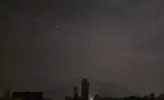 Red projectiles are seen over Srinagar, in Indian controlled Kashmir, Saturday, May 10, 2025. (AP Photo/Mukhtar Khan)
