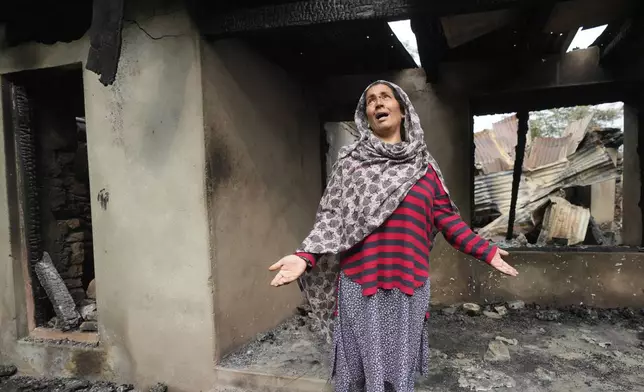 Rubina Begum wails as she stands outside her house damaged by Pakistani artillery shelling, at Salamabad village in Uri ,north of Srinagar, Indian controlled Kashmir, Thursday, May 8, 2025. (AP Photo/Mukhtar Khan)