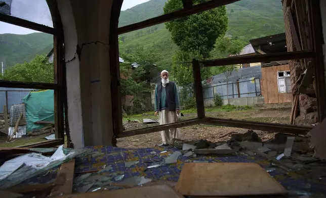 An elderly Kashmiri villager Mohammad Saleem inspects a damaged house after overnight shelling from Pakistan at Gingal village in Uri district, Indian controlled Kashmir, Friday, May 9, 2025. (AP Photo/Dar Yasin)