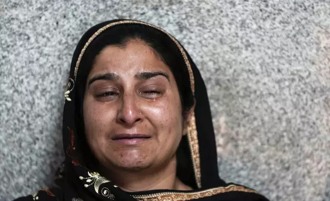 Rameez Khan's wife cries at the hospital where her husband was brought after he was injured during the Pakistani artillery shelling, in Rajouri, India, Wednesday, May 7, 2025. (AP Photo/Channi Anand)