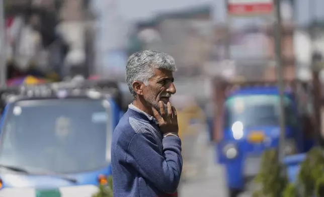 A Kashmiri man waits for transport at market, day after the ceasefire between Indian and Pakistan, in Srinagar, in Indian controlled Kashmir, Sunday, May 11, 2025.(AP Photo/Mukhtar Khan)