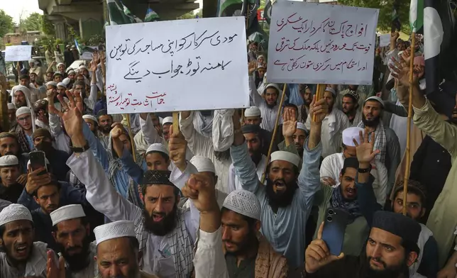 Supporters of a religious group chant anti-India slogans during a demonstration to condemn Indian strikes in Pakistan and to show their support with Pakistan's Army, in Peshawar, Pakistan, Saturday, May 10, 2025. (AP Photo/Muhammad Sajjad)