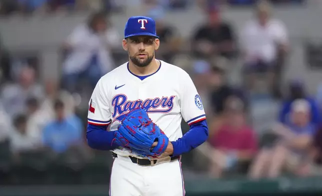 Texas Rangers starting pitcher Nathan Eovaldi looks on before making a pitch to the Toronto Blue Jays during the second inning of a baseball game Tuesday, May 27, 2025, in Arlington, Texas. (AP Photo/Julio Cortez)