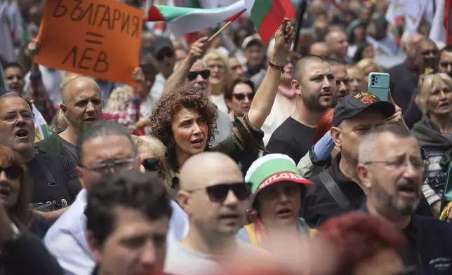 People shout slogans as thousands Bulgarians took on the streets of the capital, Sofia, and other major cities on Saturday to protest government plans to adopt the euro and to demand a referendum on the issue. Sofia, Saturday, May 31, 2025. (AP Photo/Valentina Petrova)