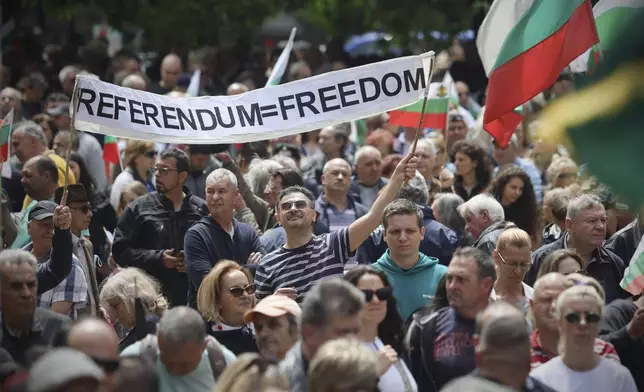 A man carries a banner as thousands Bulgarians took on the streets of the capital, Sofia, and other major cities on Saturday to protest government plans to adopt the euro and to demand a referendum on the issue. Sofia, Saturday, May 31, 2025. (AP Photo/Valentina Petrova)