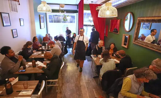 Chef Phila Lorn walks through his restaurant, Mawn, after opening for the day in Philadelphia, Thursday, May 22, 2025. (AP Photo/Matt Rourke)