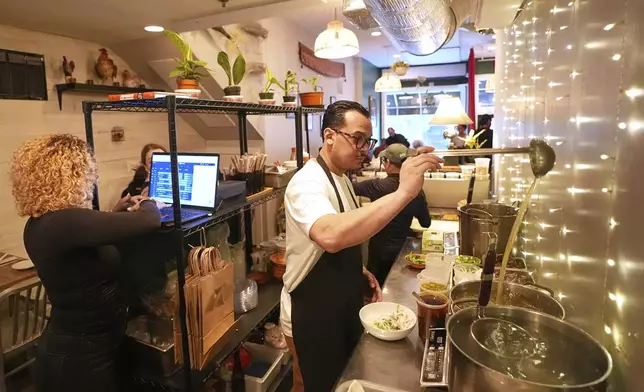 Chef Phila Lorn and Rachel Lorn work in their restaurant, Mawn, in Philadelphia, Thursday, May 22, 2025. (AP Photo/Matt Rourke)