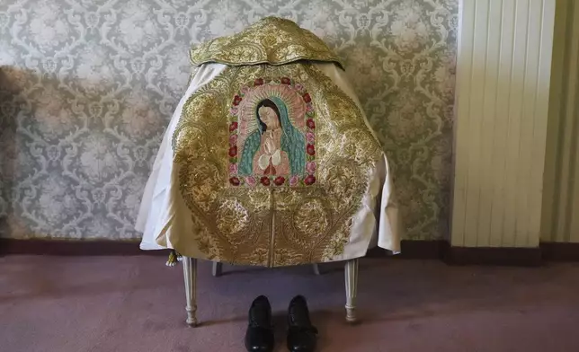 An embroidered image of the Virgin of Guadalupe decorates Mexican bullfighter Diego Silveti's capote, or bullfighter's cape, in a hotel room in Aguascalientes, Mexico, Sunday, April 27, 2025. (AP Photo/Eduardo Verdugo)