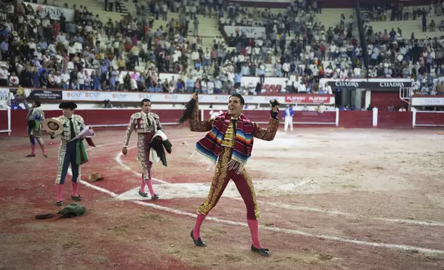 Spanish bullfighter Alejandro Talavante holds a bull's tail and ears after a bullfight in Aguascalientes, Mexico, Sunday, April 27, 2025. (AP Photo/Eduardo Verdugo)