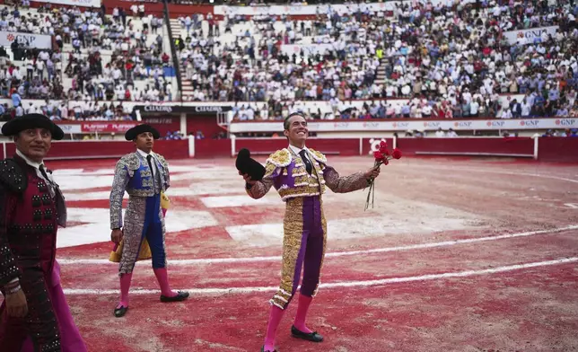 Mexican bullfighter Diego Silveti smiles at fans in the bullring after a bullfight in Aguascalientes, Mexico, Sunday, April 27, 2025. (AP Photo/Eduardo Verdugo)