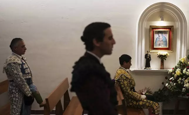 Bullfighters pray in the bullring chapel before a bullfight in Aguascalientes, Mexico, Saturday, April 26, 2025. (AP Photo/Eduardo Verdugo)