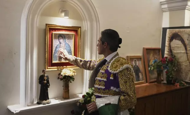Mexican bullfighter Diego Silveti touches an image of the Virgin of Guadalupe in the bullring chapel before a bullfight in Aguascalientes, Mexico, Sunday, April 27, 2025. (AP Photo/Eduardo Verdugo)