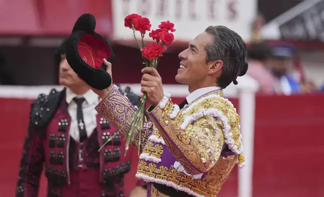 Mexican bullfighter Diego Silveti gestures to fans in the bullring after a bullfight in Aguascalientes, Mexico, Sunday, April 27, 2025. (AP Photo/Eduardo Verdugo)