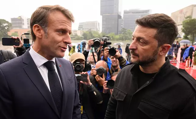 President of France Emmanuel Macron, left, and Ukraine's President Volodymyr Zelenskyy attend a summit where the leaders of 47 European countries and organizations will discuss security, defense and democratic standards, in Tirana, Albania, Friday, May 16, 2025. (Leon Neal/Pool via AP)