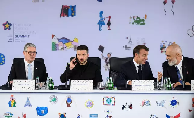 From left, Britain's Prime Minister Keir Starmer, Ukraine's President Volodymyr Zelenskyy, France's President Emmanuel Macron and Albania's Prime Minister Edi Rama attend a plenary meeting at the beginning of a summit where the leaders of 47 European countries and organizations will discuss security, defense and democratic standards, in Tirana, Albania, Friday, May 16, 2025. (Leon Neal/Pool via AP)