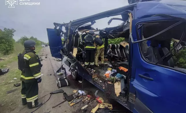 In this photo provided by the Ukrainian Emergency Service, rescuers recover the bodies of passengers after a Russian drone struck a passenger bus at the village of Bilopillya in the Sumy region, Ukraine, Saturday, May 17, 2025. (Ukrainian Emergency Service via AP)