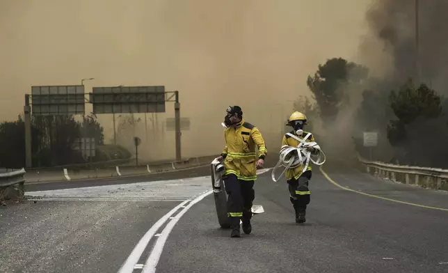Israeli firefighters work to extinguish a forest fire burning near Jerusalem, Wednesday, April 30, 2025. (AP Photo/Mahmoud Illean)