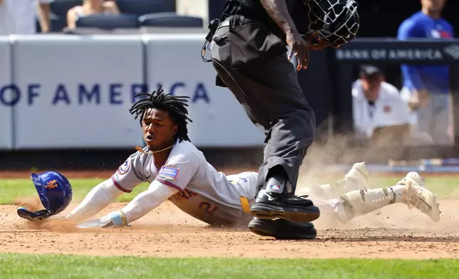 New York Mets' Luisangel Acuña (2) Scores a run on sacrifice fly by Francisco Lindor during the ninth inning of a baseball game against the New York Yankees, Saturday, May 17, 2025, in New York. (AP Photo/Noah K. Murray)