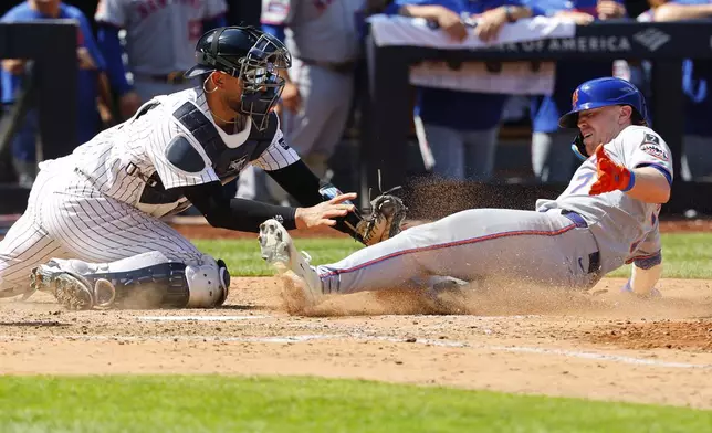 New York Yankees catcher J.C. Escarra (25) tags out New York Mets' Brett Baty (7) at home plate during the seventh inning of a baseball game, Saturday, May 17, 2025, in New York. (AP Photo/Noah K. Murray)