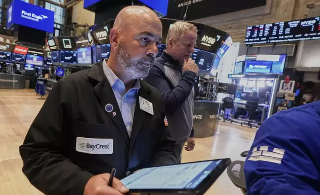 Trader Fred Demarco, left, works on the floor of the New York Stock Exchange, Thursday, May 29, 2025. (AP Photo/Richard Drew)
