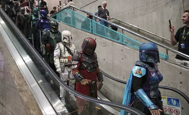 FILE - Star Wars fans in different creations of the Boba Fett uniforms attend a fan convention, the Star Wars Celebration in Chiba, near Tokyo, Friday, April 18, 2025. (AP Photo/Hiro Komae, File)