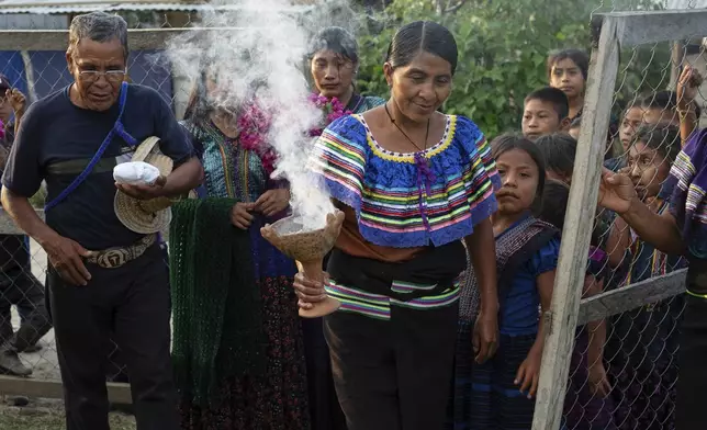Deacon Juan Pérez Gómez, left, takes part in a blessing ceremony after picking up Communion wafers that he will take to a priest to be consecrated before he can give them out in his next day service, in Nuevo Israelita, near Simojovel, Mexico, Saturday, April 26, 2025. (AP Photo/Isabel Mateos)