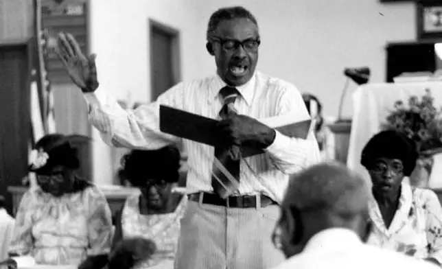 In this photo provided by the State Archives of Florida, M.L. Long leads sacred harp singers at the S.E. Alabama &amp; Florida Union Sacred Harp Sing in Campbellton, Fla., on Nov. 24, 1980. (Peggy A. Bulger/State Archives of Florida via AP)
