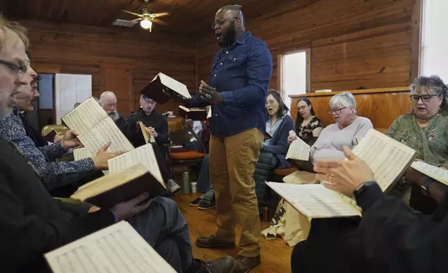 Bridge Hill Kennedy of Alabama stands in the hollow square and leads a song from "The Sacred Harp," at Holly Springs Primitive Baptist Church in Bremen, Ga., on Saturday, March 22, 2025. (AP Photo/Jessie Wardarski)